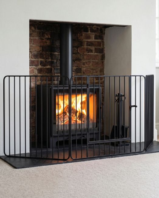 "Freyja" Heavy Duty Fire Guard With Door in Situ Next to the Fireplace "Freyja" Heavy Duty Fire Guard With Door in Situ Next to the Fireplace