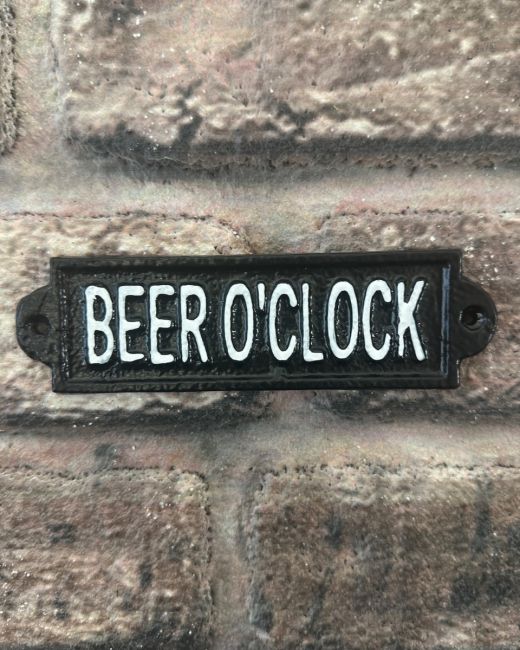 "Beer O"Clock" Traditional Cast Iron Wall Sign mounted on a brick wall