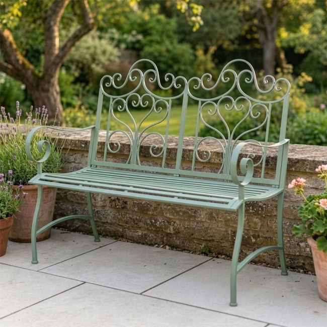 "Belvedere" Wrought Iron Garden Bench in front of hedge "Belvedere" Wrought Iron Garden Bench in front of hedge