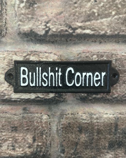 "Bullshit Corner" Traditional Cast Iron Wall Sign mounted on a brick wall