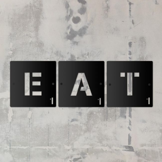 "EAT" Black Scrabble Square Letters in situ on a Rustic Wall "EAT" Black Scrabble Square Letters in situ on a Rustic Wall