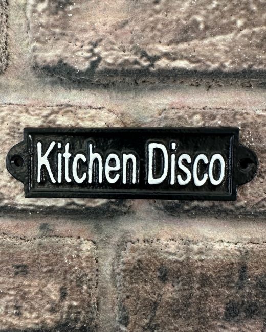 "Kitchen Disco" Traditional Cast Iron Wall Sign mounted on a brick wall