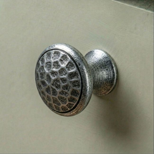 A 20mm Hammered Pewter Small Cabinet Knob Mounted on a Contemporary Sage Kitchen Cabinet - Digital Illustration 