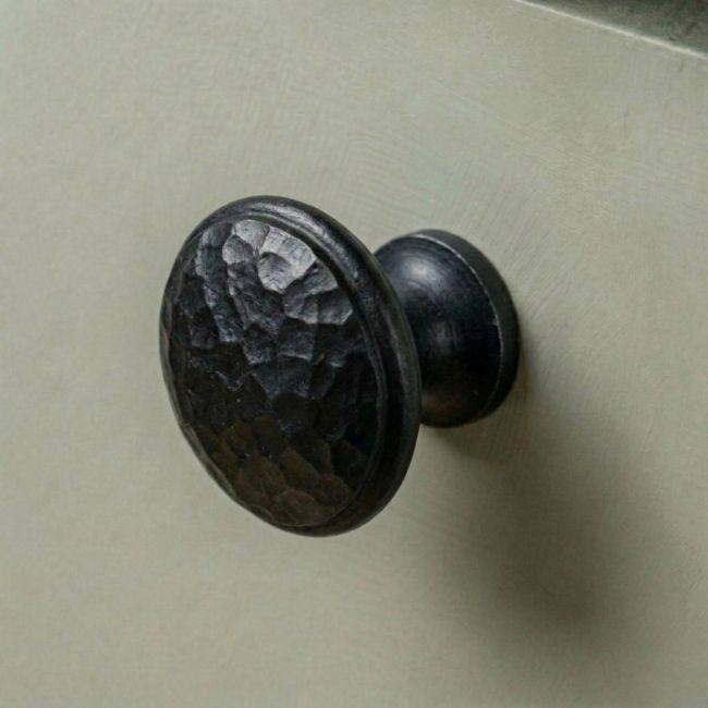 A 30mm Hammered Beeswax Cabinet Knob Mounted on a Green Contemporary Kitchen Cupboard - Digital Illustration 