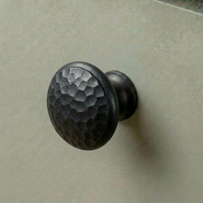 A 40mm Beeswax Hammered Iron Cabinet Knob Mounted on a Contemporary Green Kitchen Cupboard - Digital Illustration 