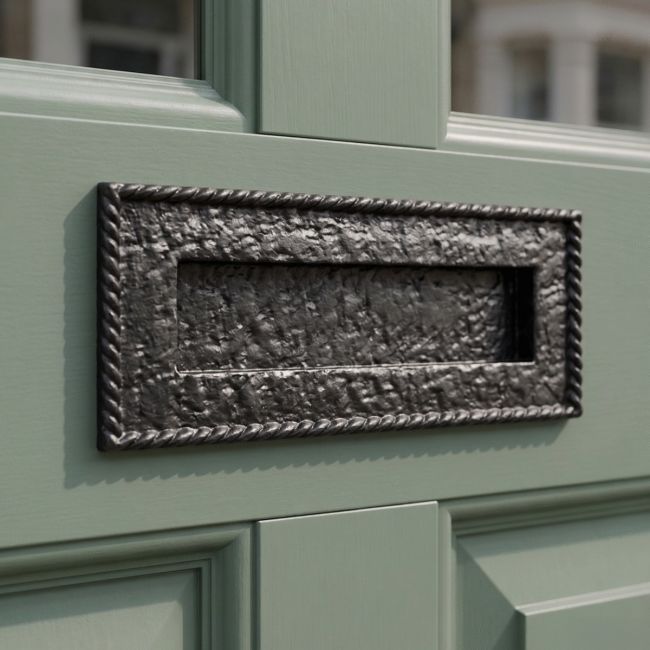 A Cast Iron Black Letter Plate With Scrolled Edge on a Sage Green Door with Glass Panels - Digital Illustration A Cast Iron Black Letter Plate With Scrolled Edge on a Sage Green Door with Glass Panels - Digital Illustration