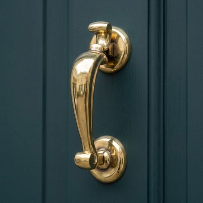 Aged Brass Traditional Doctors Door Knocker Close Up Aged Brass Traditional Doctors Door Knocker Close Up