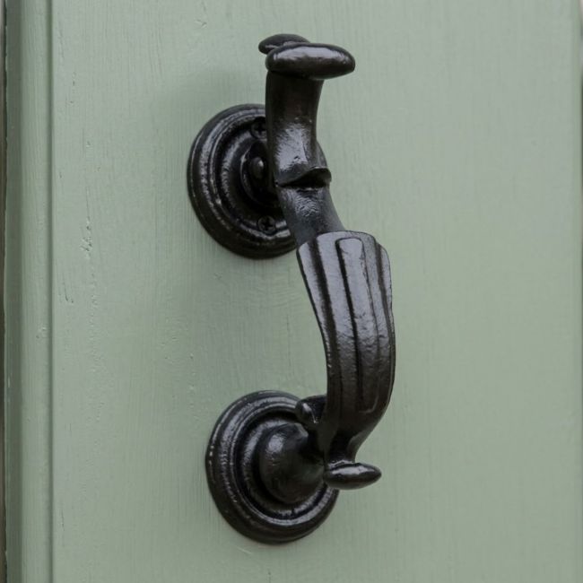 A Close up of the "Belgrave Manor" Cast Iron Victorian Door Knocker on a Sage Green Door - Digital Illustration
