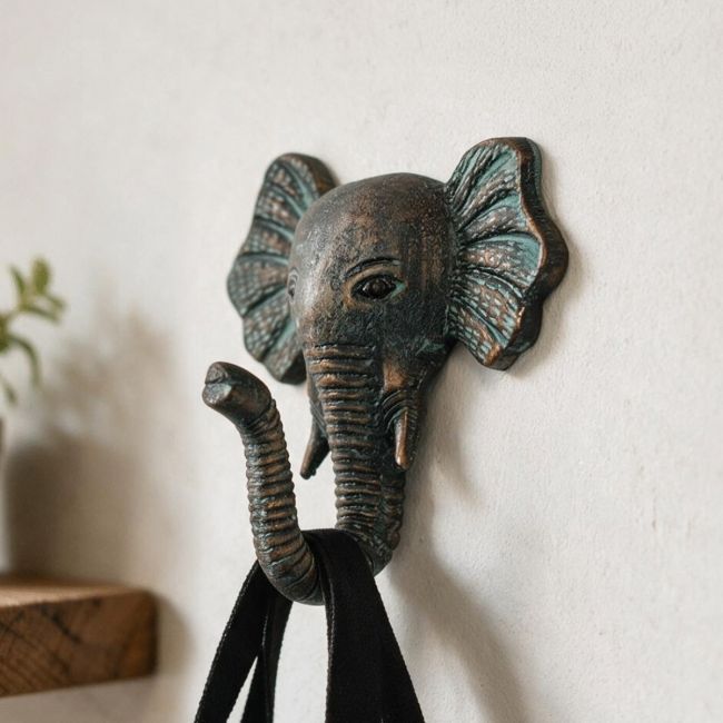A Close up of the Verdigris Elephant Hook on a Sand Coloured Wall next to a Shelf - Digital Illustration A Close up of the Verdigris Elephant Hook on a Sand Coloured Wall next to a Shelf - Digital Illustration
