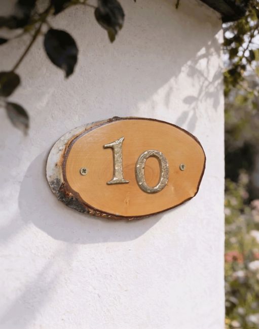 A Number 10 Natural Hard Wood Rustic House Number Sign Mounted on a Sunny White Garden Wall - Digital Illustration A Number 10 Natural Hard Wood Rustic House Number Sign Mounted on a Sunny White Garden Wall - Digital Illustration