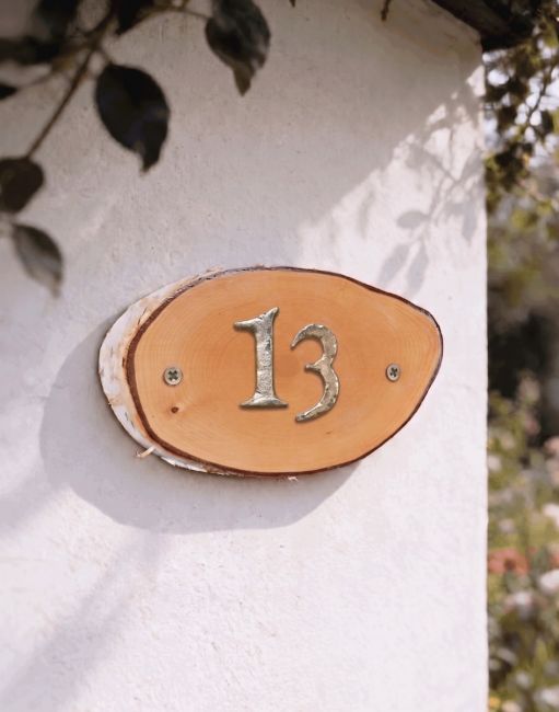 A Number 13 Natural Hard Wood Rustic House Number Sign Mounted on a White Cottage Garden Wall - Digital Illustration A Number 13 Natural Hard Wood Rustic House Number Sign Mounted on a White Cottage Garden Wall - Digital Illustration