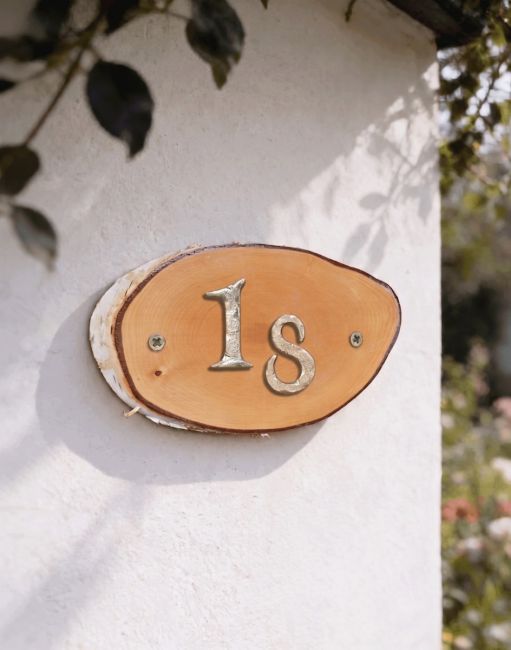 A Number 18 Natural Hard Wood Rustic House Number Sign Mounted on a Sunny Cream Coloured Wall - Digital Illustration A Number 18 Natural Hard Wood Rustic House Number Sign Mounted on a Sunny Cream Coloured Wall - Digital Illustration