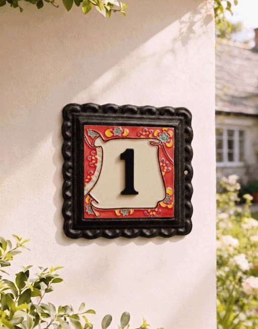 A Number 1 "Scarlett Blooms" Small Iron & Tile House Number Sign Mounted on a Cream Coloured Cottage wall - Digital Illustration