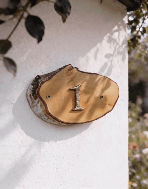 A Number 1 Natural Hard Wood Rustic House Number Sign Mounted on a Sunny White Coloured Cottage Wall - Digital Illustration A Number 1 Natural Hard Wood Rustic House Number Sign Mounted on a Sunny White Coloured Cottage Wall - Digital Illustration