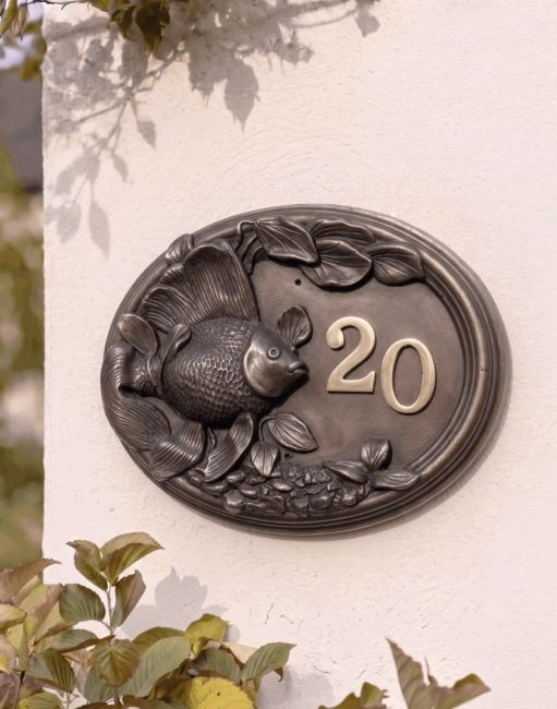 A Number 20 "Highcote Waters" Goldfish House Sign Mounted on a Sunny House Exterior Wall - Digital Illustration