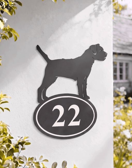 A Number 22 Border Terrier Iron House Number Sign Mounted on a White Coloured Country Property Home - Digital Illustration
