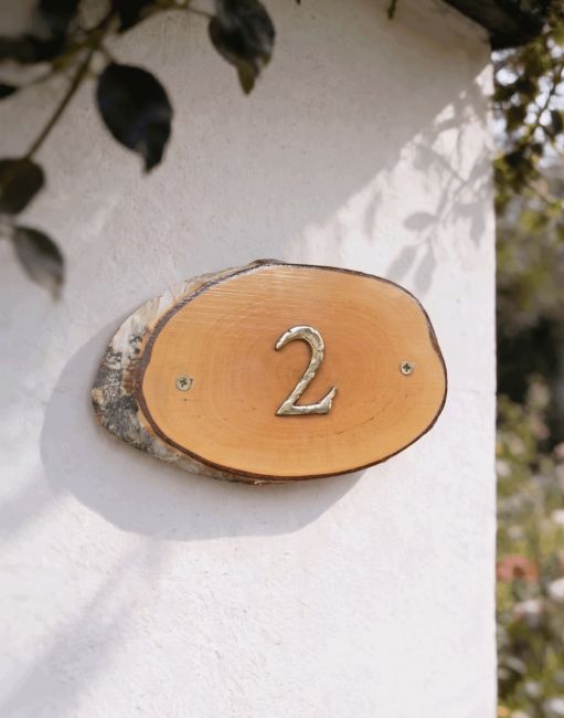 A Number 2 Natural Hard Wood Rustic House Number Sign Mounted on a Cream White Cottage Wall - Digital Illustration A Number 2 Natural Hard Wood Rustic House Number Sign Mounted on a Cream White Cottage Wall - Digital Illustration