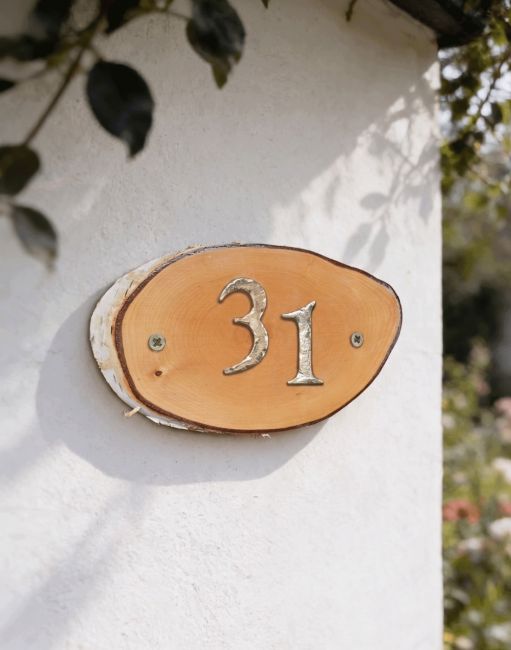 A Number 31 Natural Hard Wood Rustic House Number Sign Mounted on a Sunny White Cottage Wall - Digital Illustration A Number 31 Natural Hard Wood Rustic House Number Sign Mounted on a Sunny White Cottage Wall - Digital Illustration