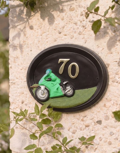 A Number 70 Hand Painted Sport Touring Motorbike House Sign Mounted on a Cream Coloured Sunny Cottage Wall - Digital Illustration