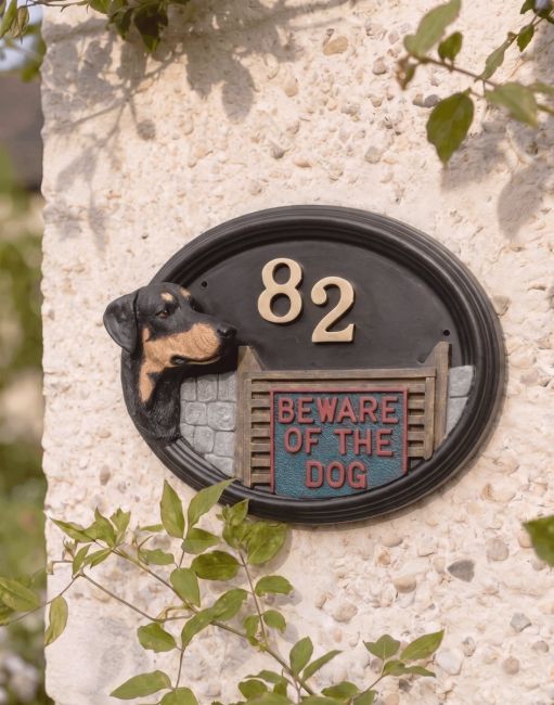 A Number 82 Doberman Hand Painted House Sign Mounted on a Pebble Cottage Wall - Digital Illustration 