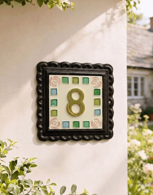 A Number 8 "Pink Roses" Mosaic Iron & Tile House Number Sign Mounted on a Sunny White Cottage Garden Wall - Digital Illustration 