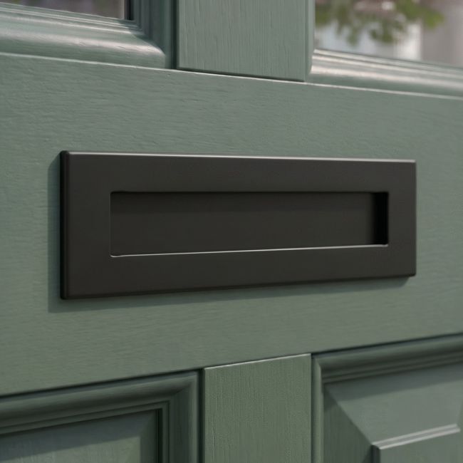 The Aged Bronze Traditional Sleeved Door Letterbox Set on a White Background The Aged Bronze Traditional Sleeved Door Letterbox Set on a White Background
