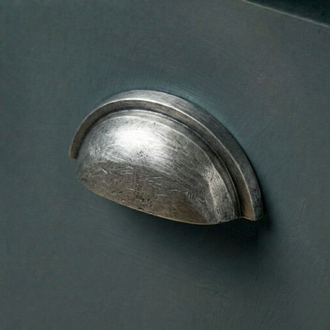 An Aged Pewter Concealed Drawer Pull Mounted on a Contemporary Blue Kitchen Drawer - Digital Illustration