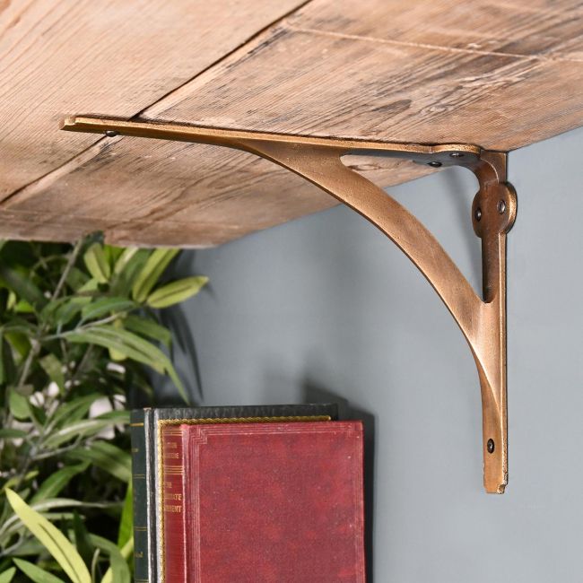 Looking up at the Cast Iron Stylish Architectural Shelf Bracket Holding up a Shelf Looking up at the Cast Iron Stylish Architectural Shelf Bracket Holding up a Shelf