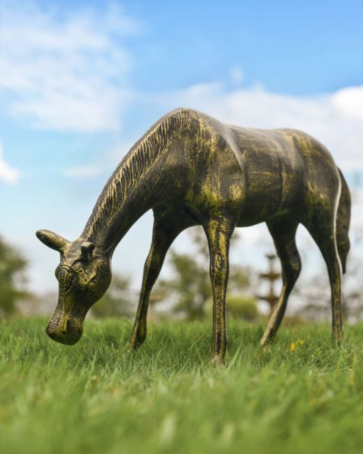 Black and gold grazing horse sculpture three quarter view