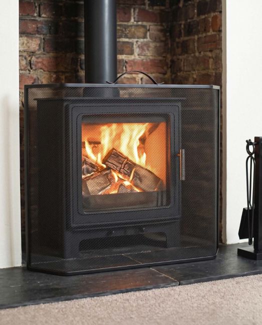 Black Contemporary Curved Fire Guard with Handle In A Fireplace Setting Black Contemporary Curved Fire Guard with Handle In A Fireplace Setting