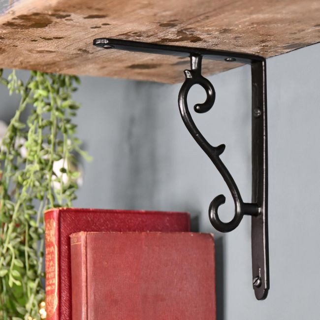 Black Shelf Bracket Holding Up a Wooden Shelf Black Shelf Bracket Holding Up a Wooden Shelf