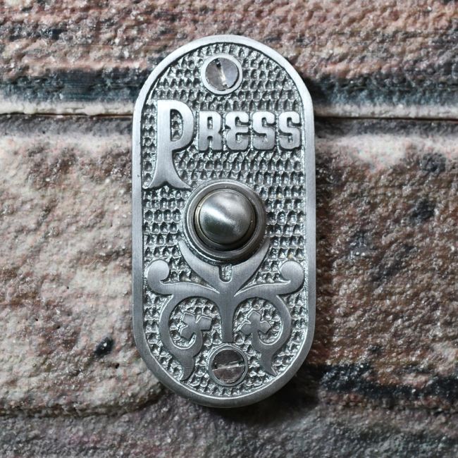 Old fashioned front door bell push on brick wall Old fashioned front door bell push on brick wall