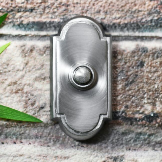 Old Fashioned Arched Door Bell Button on Brick Wall Old Fashioned Arched Door Bell Button on Brick Wall