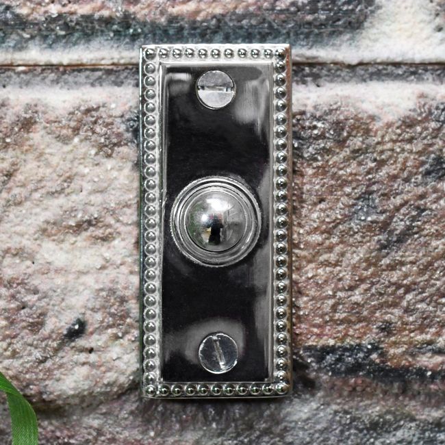 Georgian bell push on brick wall finished in bright chrome Georgian bell push on brick wall finished in bright chrome