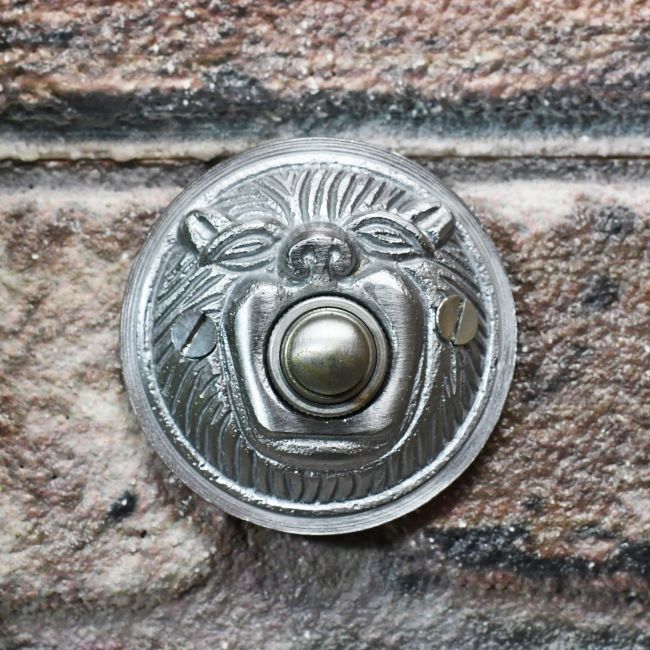 Satin Chrome door bell on brick wall Satin Chrome door bell on brick wall
