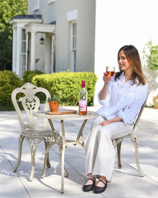 Woman Sat at Two Seater Garden Furniture 