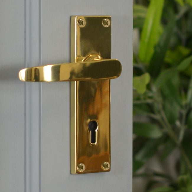 Polished Brass Lever Handle With Key Hole on Grey Door Polished Brass Lever Handle With Key Hole on Grey Door