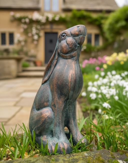 Digital illustration of a large verdigris ‘Meadow’ Cast Aluminium Rabbit Looking Up in a flowery garden