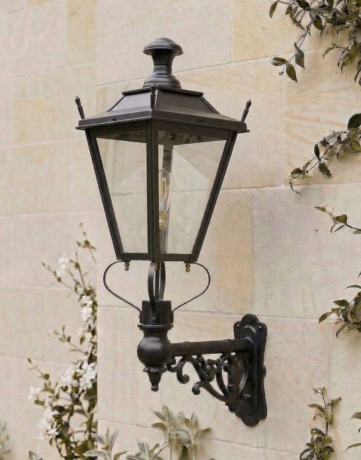 Digital Illustration of the 102 x 54cm Black Dorchester Wall Lantern on an Ornate Bracket Mounted on a Sandstone Brick Wall