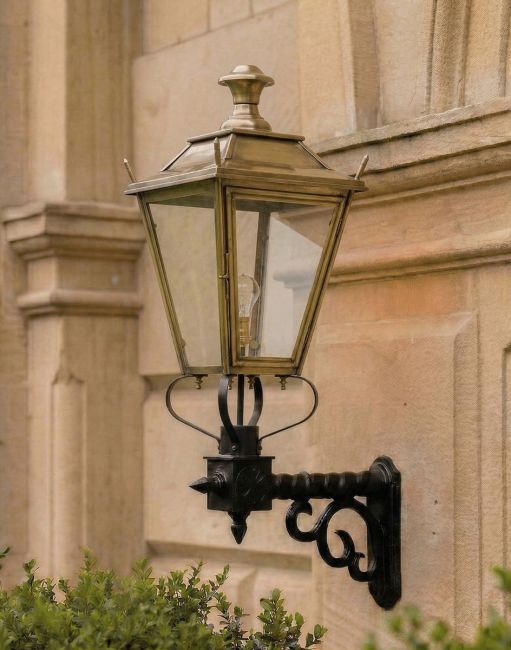 Digital Illustration of the 102 x 54cm Brass Dorchester Wall Lantern on a Royale Bracket Mounted on a Grand Building Entrance Wall 