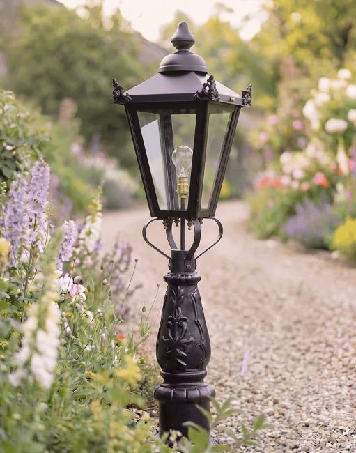 Digital Illustration of the 105cm "Crown Riversham" Black Victorian Patio Lamp Post Set Positioned on a Flowery Gravel Drive Entranceway