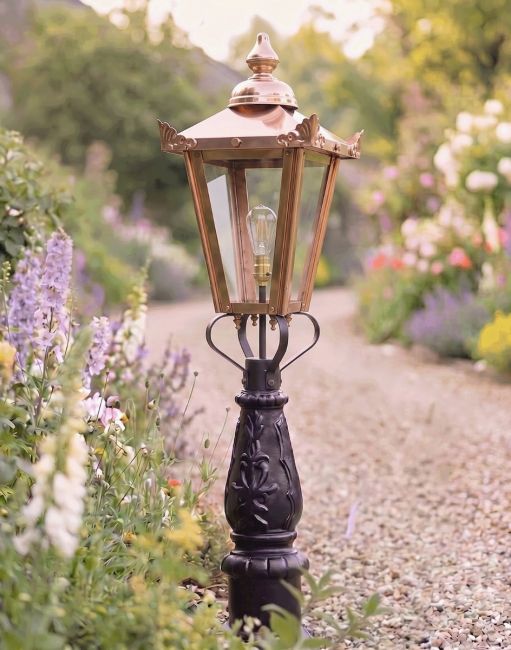 Digital Illustration of the 105cm "Crown Riversham" Copper Victorian Patio Lamp Post Placed on a Flowery Gravel Driveway