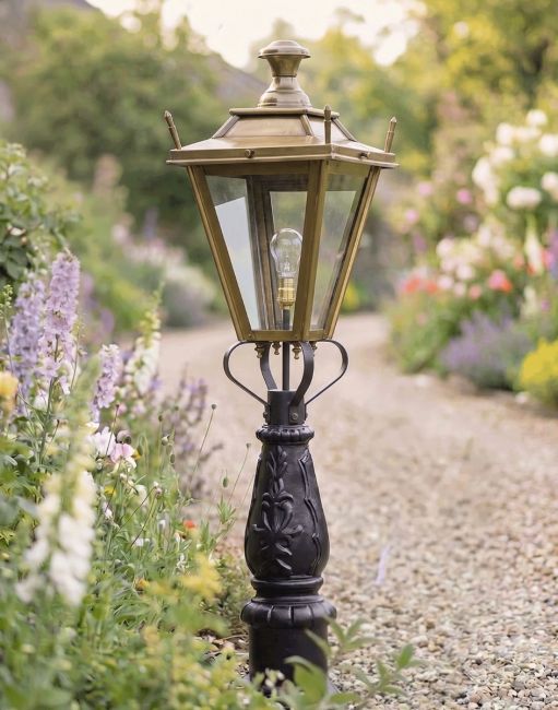 Digital Illustration of the 105cm Antique Brass Dorchester Driveway Light Positioned on a Flowery Gravel Entrance