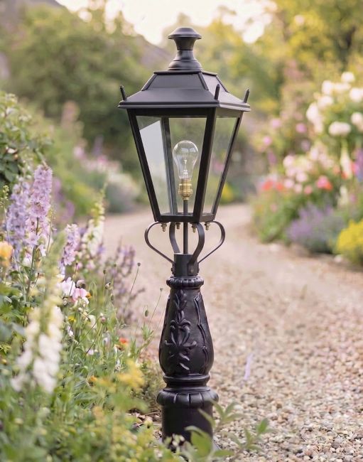 Digital Illustration of the 105cm Black Dorchester Driveway Light Placed on a Flowery Gravel Entranceway