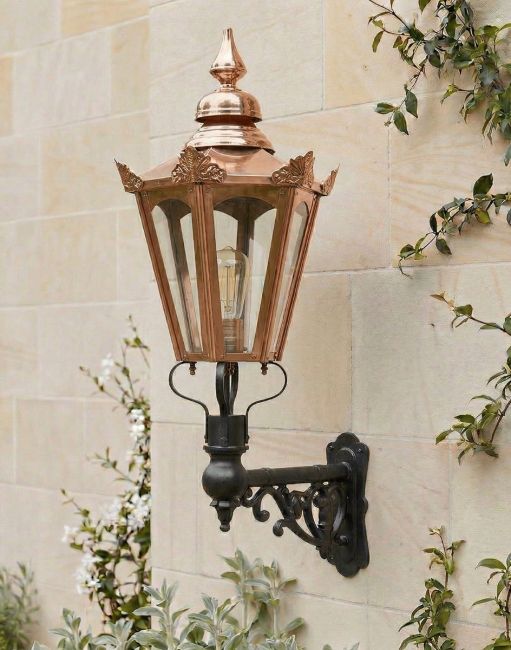 Digital Illustration of the 115 x 53cm Copper Hexagonal Wall Lantern on an Ornate Bracket Mounted on a Sandstone Brick Garden Wall