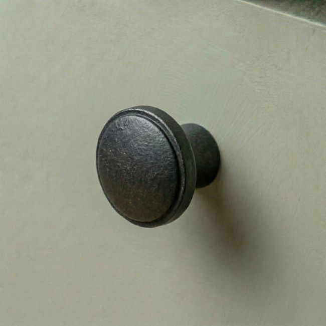 Digital Illustration of the 32mm Steel Beeswax Cabinet Knob Mounted on a Green Cupboard Door