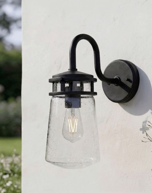 Digital Illustration of the 38cm "Elmwood" Vintage Bronze Seeded Glass Lantern Fixed to a White Wall in a Sunny Garden