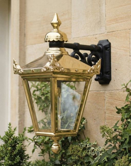 Digital Illustration of the 63 x 47.5cm Version of the Polished Brass Suspended Wall Lantern Mounted on a Grand Sandstone Walled Building