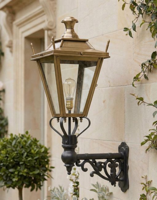 Digital Illustration of the 84 x 37cm Brass Dorchester Wall Lantern on an Ornate Bracket Mounted on a House Entranceway