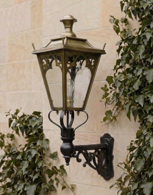 Digital Illustration of the 95 x 48cm Brass Gothic Wall Lantern on an Ornate Bracket Mounted on a Sandstone Brick Building Wall